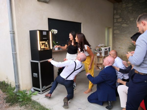 photobooth noir qui prend en photo d'un groupe de personnes qui prennent la pause lors d'un mariage